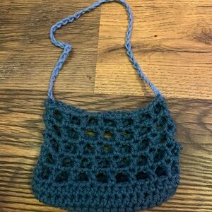 Hand crocheted mini bag made with forest green and light blue colouring